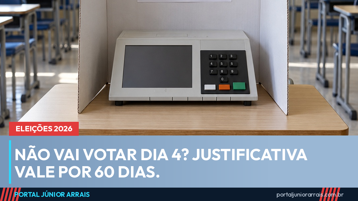 Cabine de votação com urna eletrônica sobre a mesa e placa vote aqui, em sala de aula de escola pública